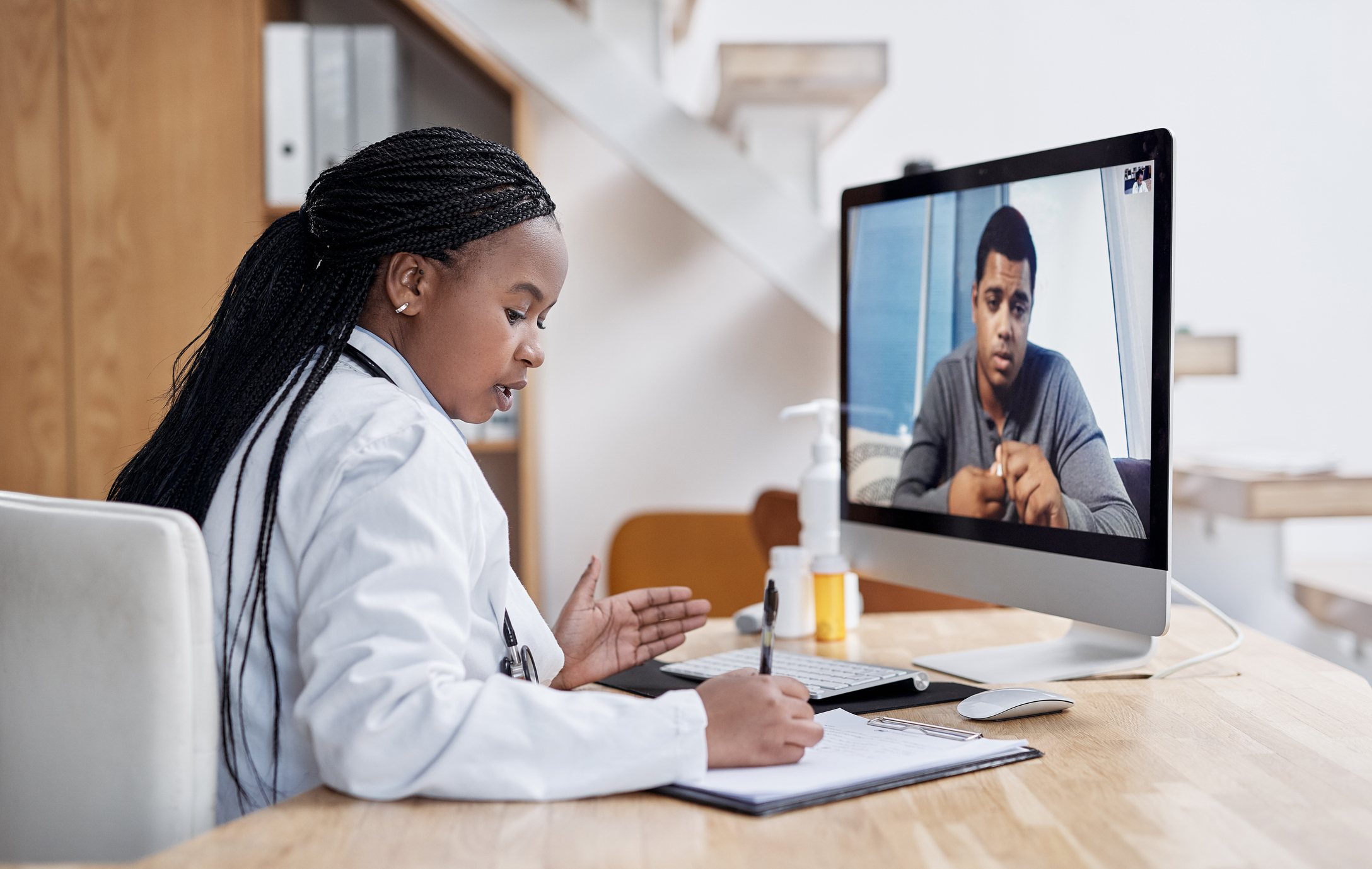 ALT Text: Medical Professional Speaking with a Patient through a virtual appointment 